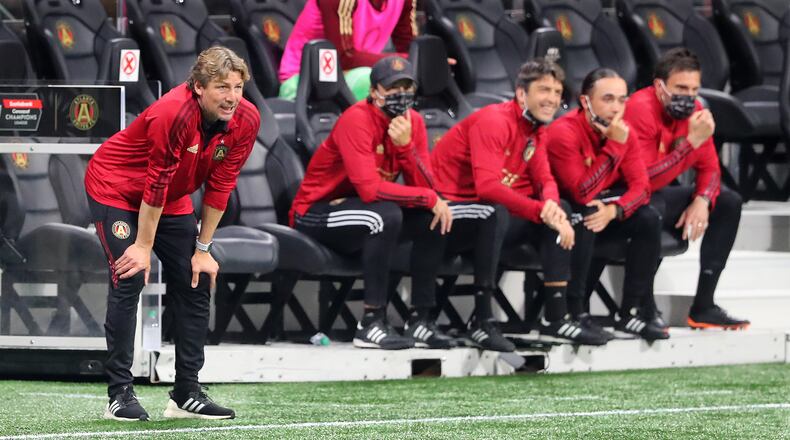 Atlanta United head coach Gabriel Heinze (far left) and his coaching staff look over the team as they face the Philadelphia Union in a Champions League quarterfinals match Tuesday, April 27, 2021, in Atlanta. (Curtis Compton / Curtis.Compton@ajc.com)