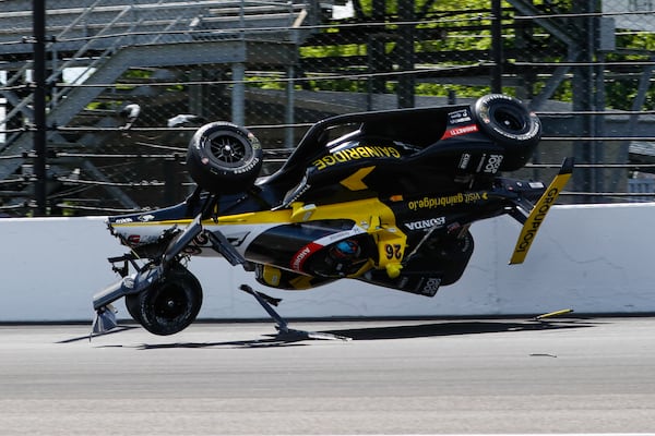 The car driven by Colton Herta goes airborne after hitting the wall in the first turn during a qualification attempt for the Indianapolis 500 auto race at Indianapolis Motor Speedway in Indianapolis, Saturday, May 17, 2025. (AP Photo/Kirk DeBrunner)