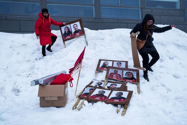Women carry political placards for the upcoming elections in Nuuk, Greenland, Saturday, March 8, 2025. (AP Photo/Evgeniy Maloletka)
