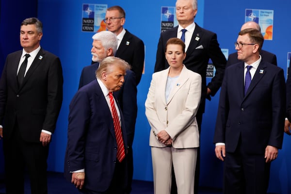 President Donald Trump, center left, walks by Denmark's Prime Minister Mette Frederiksen, center front, prior to a group photo of NATO heads of state and government at the NATO summit in The Hague, Netherlands, Wednesday, June 25, 2025. (AP Photo/Geert Vanden Wijngaert)