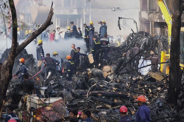 Search and rescue teams respond to the scene of a plane crash in Ahmedabad, India, Thursday, June 12, 2025. (AP Photo/Ajit Solanki)
