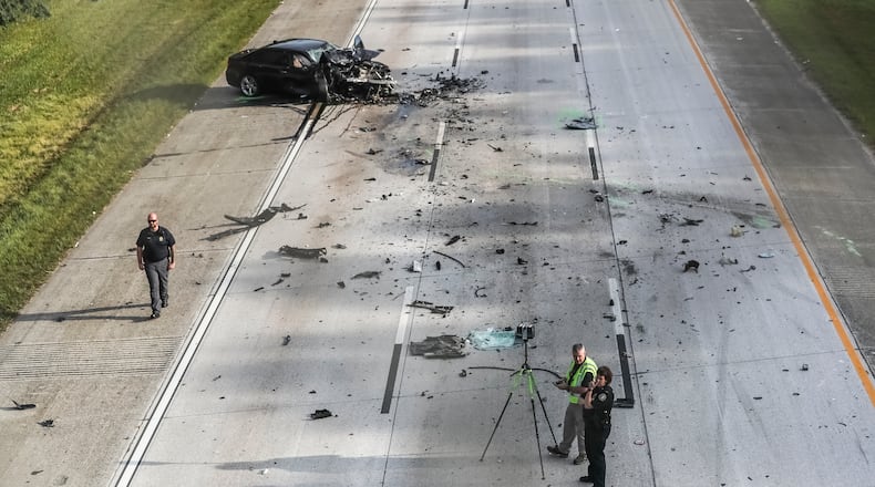 August 9, 2023 Clayton County: One person is dead after a driver sped away from an off-duty officer in the wrong direction on I-675 South and crashed into three other vehicles Wednesday morning, Aug. 9, 2023. Clayton County police have shut down the interstate to investigate the crash, which happened around 6:30 a.m. near the Forest Parkway exit in Ellenwood. Commuters are urged to avoid the area as the investigation is likely to span “multiple hours,” a spokesperson for the department said. Mangled vehicles and debris are scattered across all three lanes, including a wheel that landed in the grass next to a teddy bear. Police said an off-duty officer was on his way home, heading south on I-675, when he saw a vehicle stopped in the grassy median. It appeared the driver had been traveling north and left the road. When the officer approached, he saw the driver “passed out behind the wheel,” police said. The officer then knocked on the window and woke the driver, who “appeared to be incoherent with glassy eyes and sweating.” The driver was asked multiple times to open the door, but instead sped off in the wrong direction, according to police. By the time the officer got back to his patrol car, he could no longer see the vehicle. After driving about a mile down the interstate, the officer came upon the wreckage that spanned all three lanes of the interstate. The driver he encountered had crashed into three other vehicles. Another driver was killed, according to police, and has yet to be identified. Officials said it is unclear if the fleeing driver was impaired or experiencing a medical emergency. No other details were released about the crash, including the condition of the alleged wrong-way driver or the survivors in the other vehicles. The front end of a sedan was crushed, as was an SUV that also sustained severe damage to its side. (John Spink / John.Spink@ajc.com)