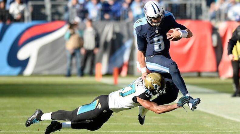 Tennessee Titans quarterback Marcus Mariota (8) is hit by Jacksonville Jaguars cornerback Dwayne Gratz (27) in the second half of an NFL football game Sunday, Dec. 6, 2015, in Nashville, Tenn. (AP Photo/Mark Zaleski)