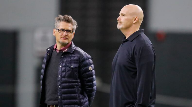Atlanta Falcons head coach Dan Quinn, right, and general manager Thomas Dimitroff watch during Georgia Pro Day, Wednesday, March 21, 2018, in Athens. Pro Day is intended to showcase talent to NFL scouts for the upcoming draft. (AP Photo/Todd Kirkland)