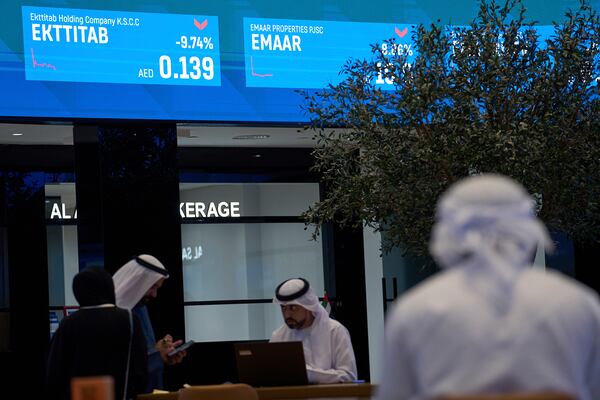 Emiratis are seen in the Dubai Financial Market in Dubai, United Arab Emirates, Monday, April 7, 2025. (AP Photos/Fatima Shbair)
