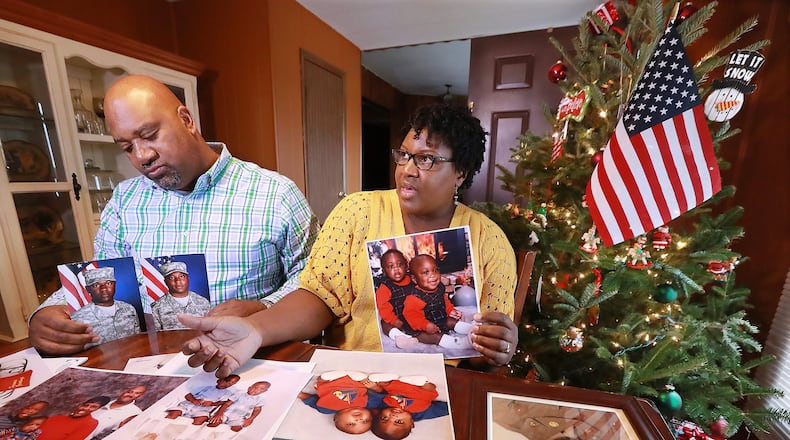 Chris and Sandra McBride look through childhood photos of their twin sons, Matthew and Ryan, at their home in Statesboro. The parents said their Christian faith helps them cope with their sons’ upcoming deployment. “We are praying about it and honestly trusting in God and believing that he is going to take care of them,” Sandra said. Curtis Compton/ccompton@ajc.com