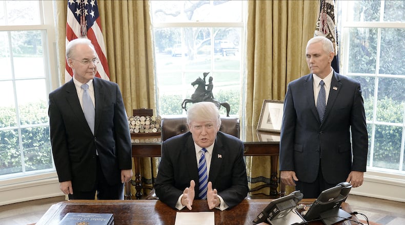 President Donald Trump with HHS Secretary Tom Price (L) and Vice President Mike Pence (R) on March 24, 2017 in Washington, DC. (Photo by Olivier Douliery-Pool/Getty Images)