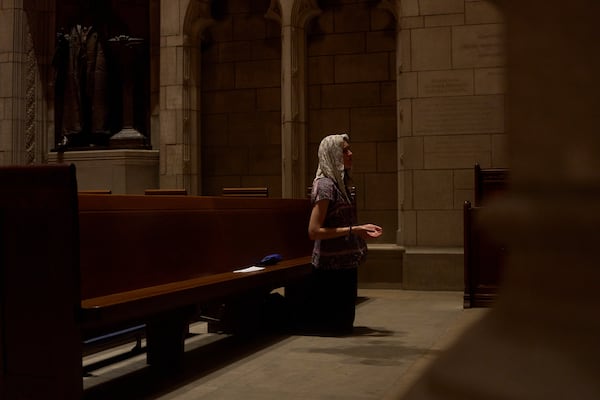 Savannah Nichols, visiting her boyfriend, altar server David Kim, from Ohio, prays after a service at the Princeton University chapel in Princeton, N.J., on Friday, May 16, 2025. (AP Photo/Luis Andres Henao)