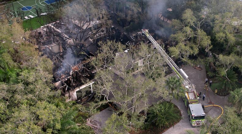 Firefighters work to extinguish the remains of a fire at a home owned by Miami Heat basketball coach Erik Spoelstra, Thursday, Nov. 6, 2025, in Miami. (AP Photo/Rebecca Blackwell)