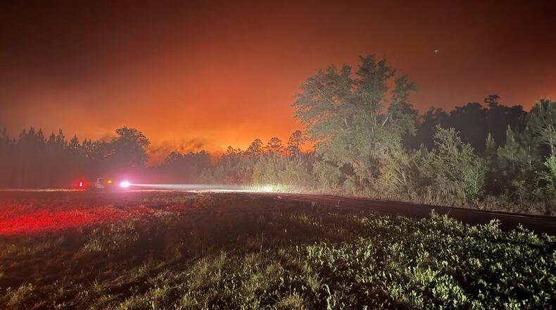 This photo provided by the Georgia Department of Natural Resources shows firefighters responding to the Pineland Road Fire in South Georgia on Monday, April 20, 2026. (Georgia Department of Natural Resources via AP)