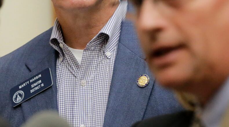 State Sen. Marty Harbin (left), looks on as Mike Griffin of the Georgia Baptist Mission Board speaks about the "religious liberty" legislation in 2016. BOB ANDRES / BANDRES@AJC.COM