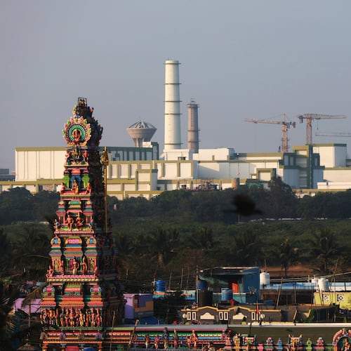 FILE - A temple stands in the foreground of the Madras Atomic Power Station located at Kalpakkam, in the Indian state of Tamil Nadu, Feb. 10, 2025. (AP Photo/R. Parthibhan, File)