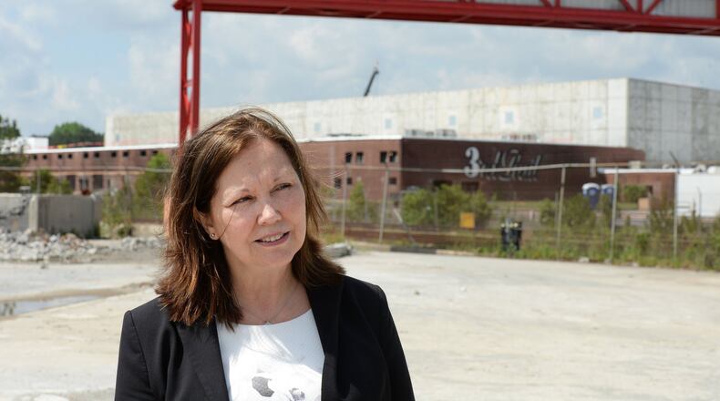 Doraville Mayor Donna Pittman walks through the construction site of Third Rail Studios in May 2016, one of the first developments at the former General Motors site. KENT D. JOHNSON /kdjohnson@ajc.com