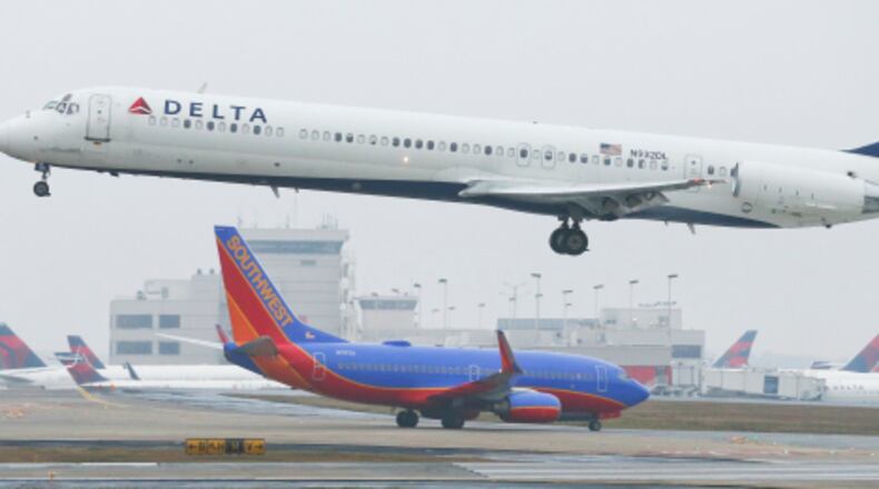 LEDE PHOTO - January 14, 2015 Hartsfield-Jackson International Airport: A Delta jet takes off on Wednesday, Jan. 14, 2015. Hartsfield-Jackson International Airport has lost one of its two titles for world's busiest airport, with Chicago O'Hare taking the title for the most flights, according to year-end data from Flight Aware. Atlanta still carries millions more passengers, but for many years it held both titles. The decline in takeoffs and landings in Atlanta came as Delta Airlines retires regional jets and replaces them with larger planes, while Southwest Airlines cut back on AirTran flights here. JOHN SPINK / JSPINK@AJC.COM