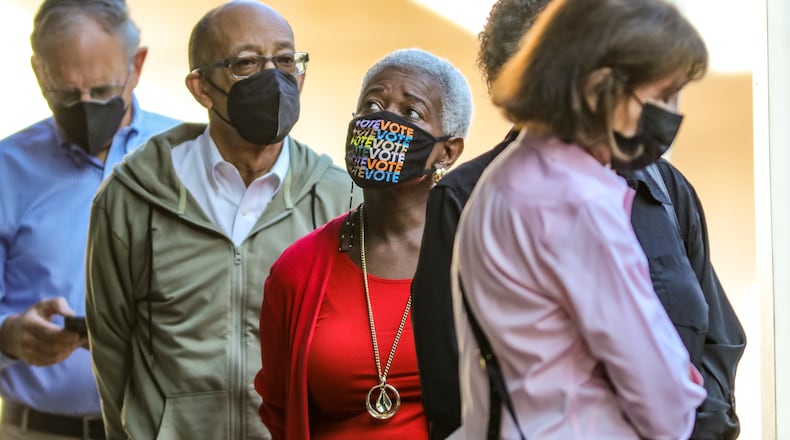 Josephine Reed-Taylor (center) waits with other voters that gathered Monday at the Buckhead Library located at 269 Buckhead Ave NE in Atlanta for early voting. (John Spink / John.Spink@ajc.com)