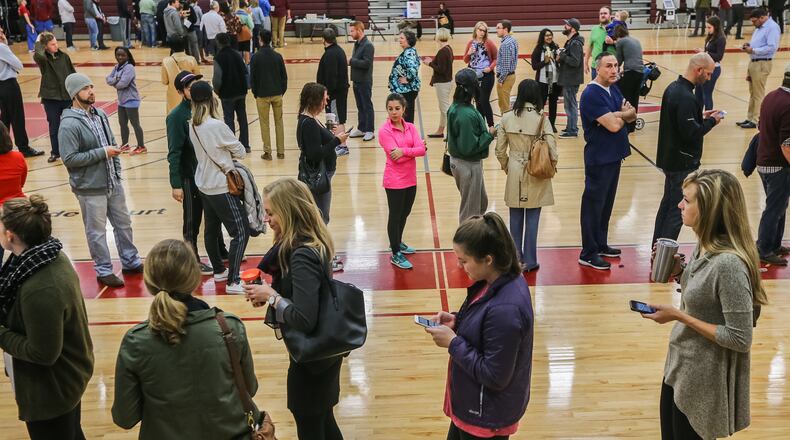A triple line of voters forms as they wait to cast votes in the Grady High School gymnasium on Tuesday morning, November 8, 2016. JOHN SPINK / JSPINK@AJC.COM