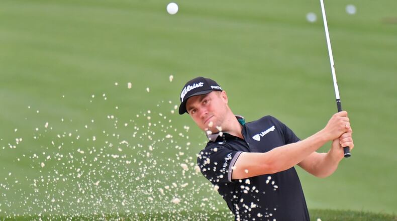 Justin Thomas hits out of a bunker on the driving range Tuesday during a practice round for the Masters at Augusta National Golf Club. (Hyosub Shin / Hyosub.Shin@ajc.com)