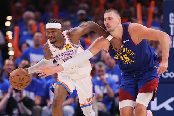 Oklahoma City Thunder's Shai Gilgeous-Alexander, left, advances the ball upcourt under pressure from Denver Nuggets center Nikola Jokic (15) in the second half of Game 5 of an NBA basketball second-round playoff series Tuesday, May 13, 2025, in Oklahoma City. (AP Photo/Nate Billings)