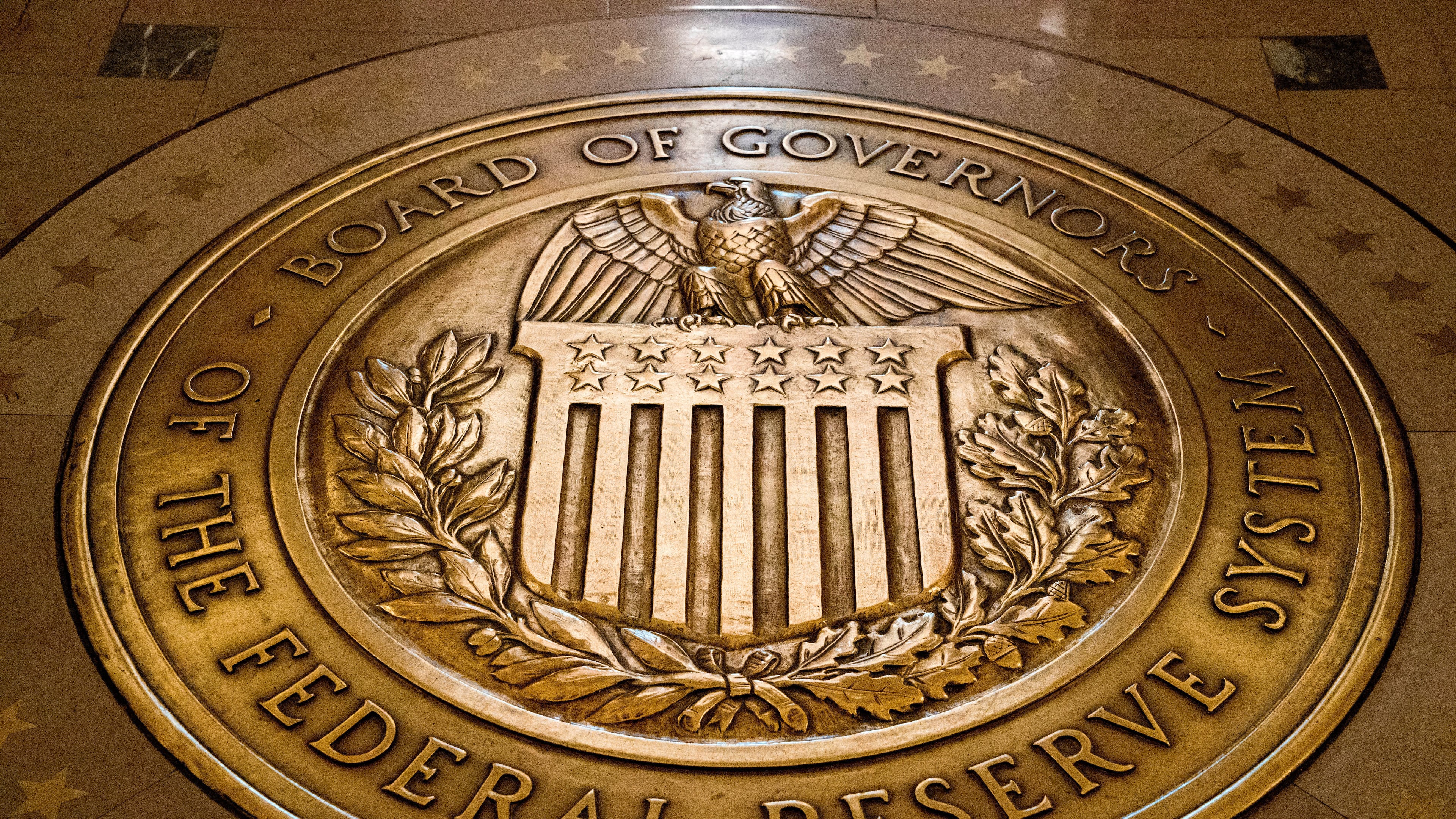 FILE- In this Feb. 5, 2018, file photo, the seal of the Board of Governors of the United States Federal Reserve System is displayed in the ground at the Marriner S. Eccles Federal Reserve Board Building in Washington. (AP Photo/Andrew Harnik, File)