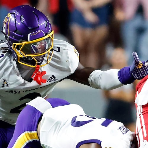 FILE - East Carolina's Ja'Marley Riddle (2) helps with a tackle during the second half of an NCAA college football game against North Carolina State in Raleigh, N.C., Aug. 28, 2025. (AP Photo/Karl DeBlaker, File)