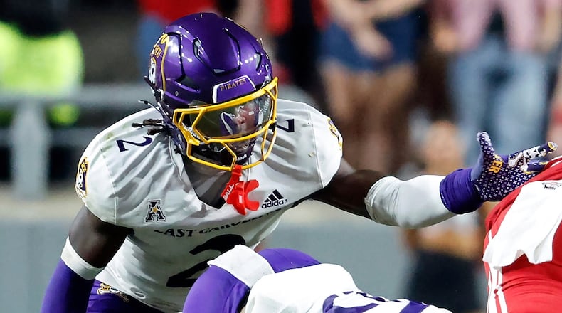 FILE - East Carolina's Ja'Marley Riddle (2) helps with a tackle during the second half of an NCAA college football game against North Carolina State in Raleigh, N.C., Aug. 28, 2025. (AP Photo/Karl DeBlaker, File)