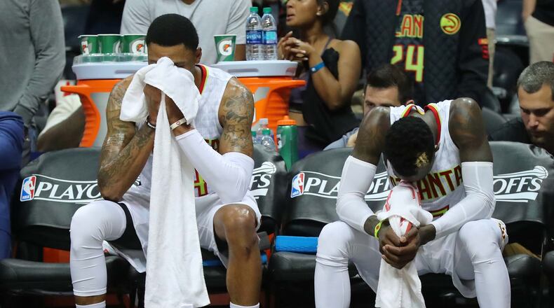 Hawks players Kent Bazemore and Dennis Schroder sit dejected on the bench in the final minute of a 115-99 playoff loss to the Washington Wizards Friday night at Philips Arena. The Hawks lost the first-round series, four games to two. (Curtis Compton/ccompton@ajc.com)