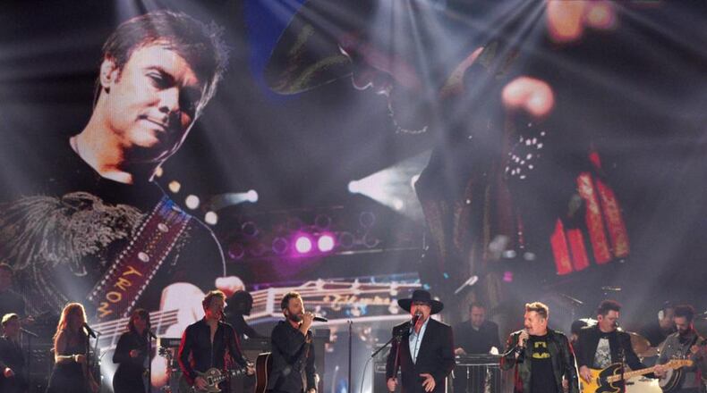 Joe Don Rooney,from left, Dierks Bentley,Eddie Montgomery,Gary LeVox, and Jay DeMarcus perform "My Town"during a tribute to Troy Gentry at the 51st annual CMA Awards at the Bridgestone Arena on Wednesday, Nov. 8, 2017, in Nashville, Tenn.