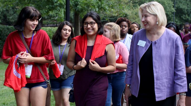 Rachel de las Casas and Natalia Rosas, (left to right) incoming first-year students at Agnes Scott College, talk to the president of the college, Leocadia (Lee) I. Zak at Agnes Scott College on Thursday, Aug. 23. JENNA EASON / JENNA.EASON@COXINC.COM