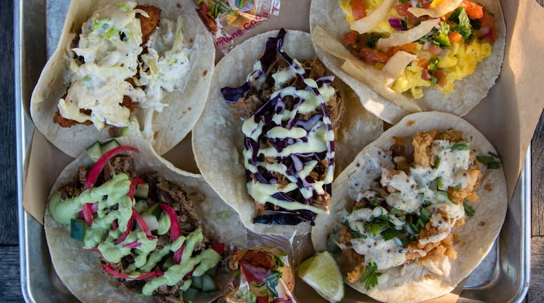 A tray of five tacos at Strange Taco Bar in Lawrenceville (clockwise from top left): fried fish, migas, fried clam, braised lamb and braised duck. CONTRIBUTED BY HENRI HOLLIS