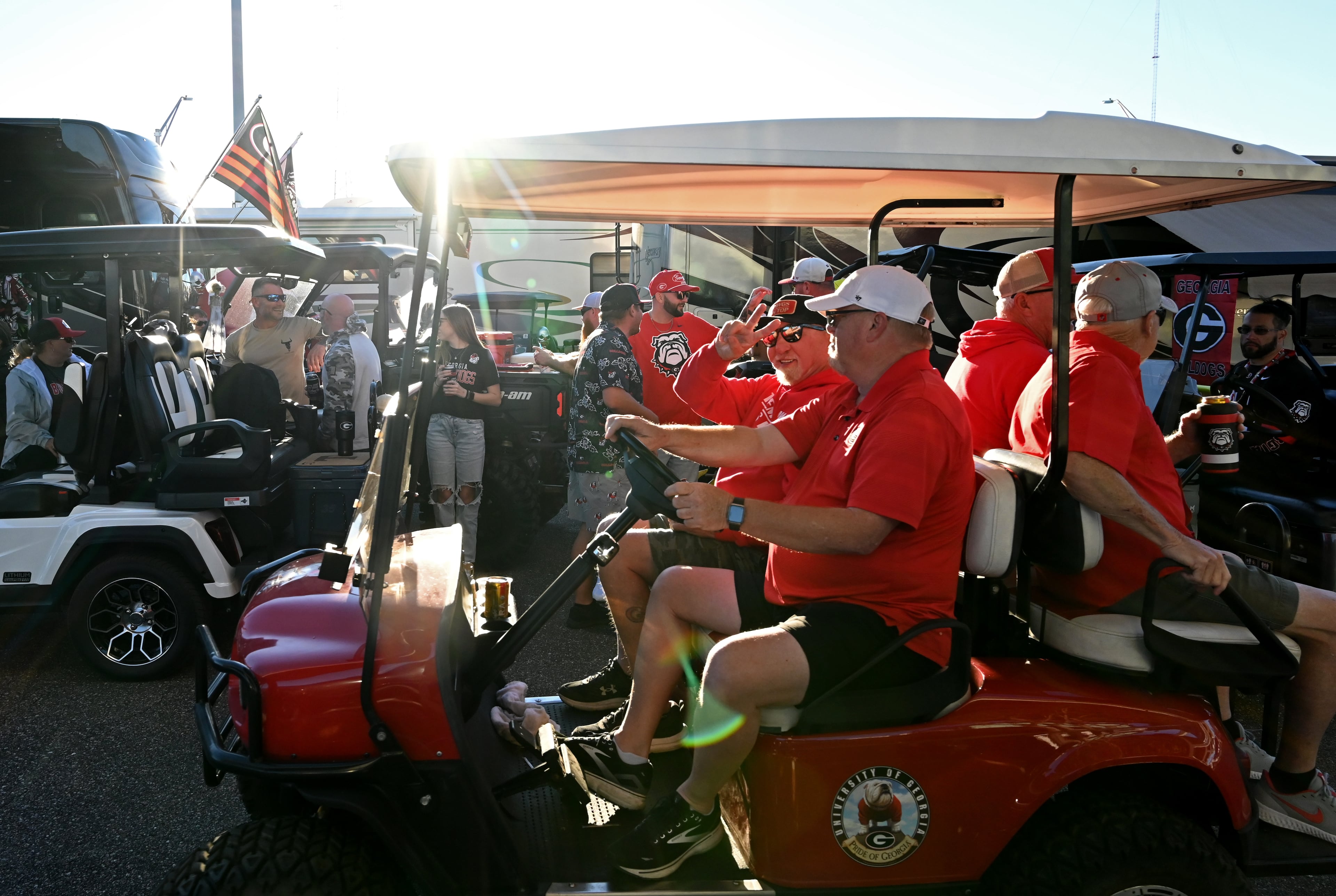 Georgia fans ride a decorated golf cart during tailgating ahead of the NCAA football game Saturday between Georgia and Florida in RV City outside EverBank Stadium, Friday, October 31, 2025, Jacksonville, Fla. (Hyosub Shin / AJC)