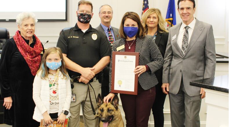 K-9 Jax (center) retired from the Snellville Police Department in October.