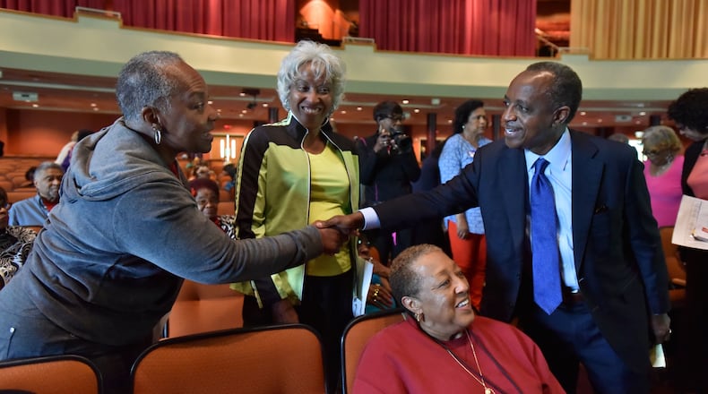 Mike Thurmond, who won the race for DeKalb County CEO on Tuesday, greets seniors Elayn Ansari and Helen Norris during at forum at Salem Bible Church in Lithonia on May 5. HYOSUB SHIN / HSHIN@AJC.COM