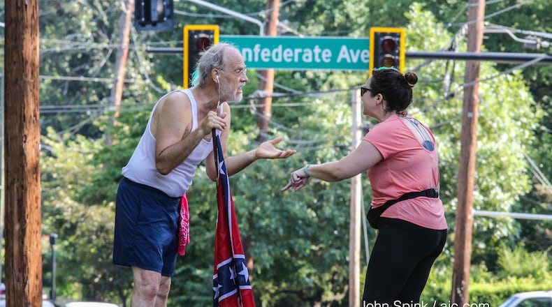 Alan Keck (left) debates Katie Kurumada on Boulevard in Grant Park. They are discussing the proposed name change of Confederate Avenue. John Spink/AJC