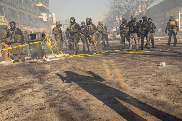 Federal agents stand near the site where agents shot and killed Alex Jeffrey Pretti, a 37-year-old Minneapolis resident, in Minneapolis on Saturday, Jan. 24, 2026. Pretti was a registered nurse who worked in the intensive-care unit at the Veterans Affairs hospital in Minneapolis, public records show, and lived in an apartment in Minneapolis a short drive away from where he was killed. (David Guttenfelder/The New York Times)