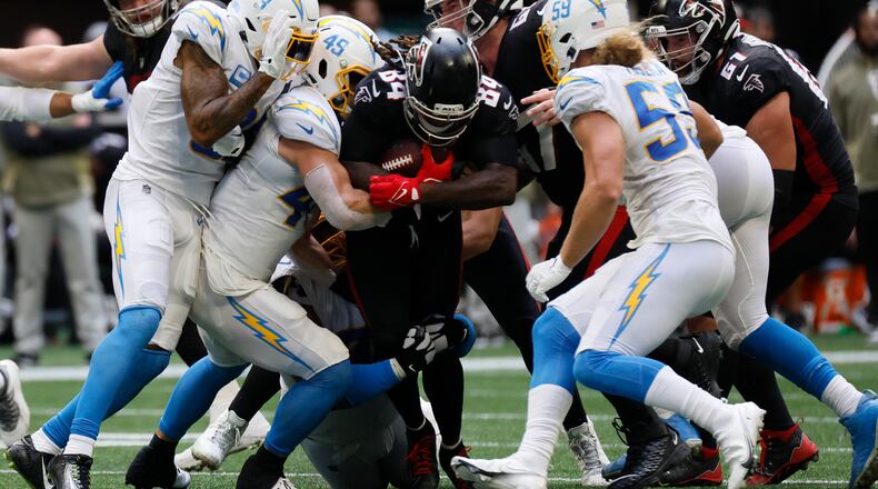 Falcons running back Cordarrelle Patterson tries to break free from Chargers defenders during the third quarter Sunday in Atlanta. (Miguel Martinez/The Atlanta Journal-Constitution/TNS)