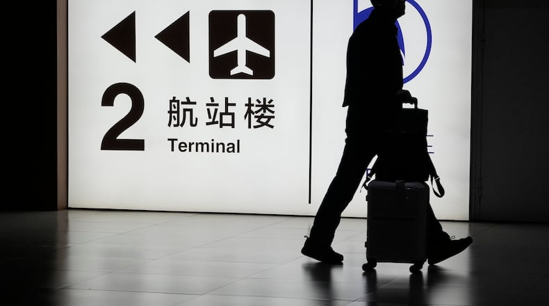 FILE - A passenger arrives at the Capital Airport in Beijing on Nov. 7, 2025. (AP Photo/Ng Han Guan, file)