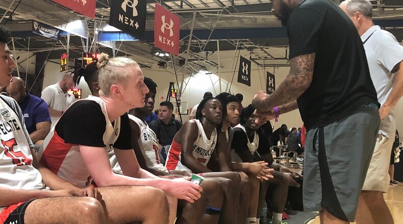 Blue Cain (black t-shirt, foreground) listens to the instruction of B. Maze Elite coach Bobby Maze during a break in action of the team's AAU game vs. the Middlesex Magic July 7, 2022 at the LakePoint Sports gymnasium in Cartersville. Cain announced his commitment to Georgia Tech on June 9, 2022. (AJC photo by Ken Sugiura)