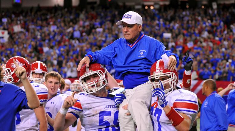 Jefferson head coach T. McFerrin is carried onto the field by Jordan Tyler (left) and Conner Nations.