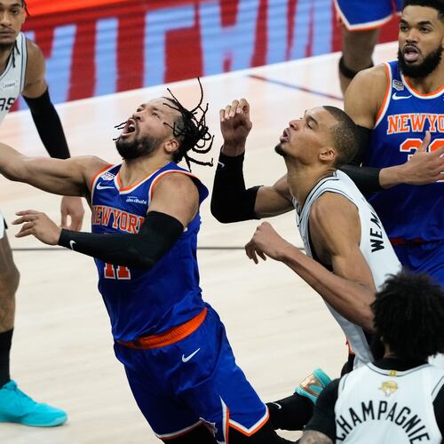 New York Knicks guard Jalen Brunson, left, drives past San Antonio Spurs forward Victor Wembanyama during the second half of Game 5 of the NBA Finals basketball series, Saturday, June 13, 2026, in San Antonio. (AP Photo/Ross D. Franklin)