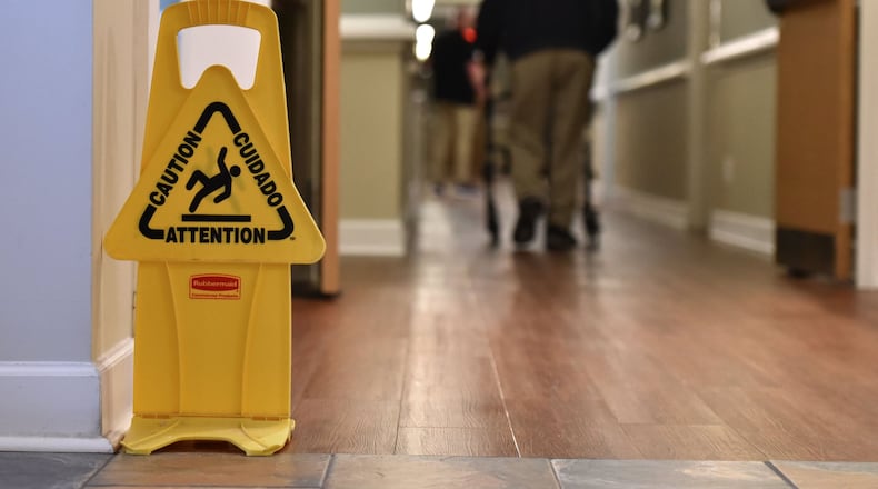 A resident of Ashton Senior Living uses a wheeled walker at the assisted living community. (Hyosub Shin / Hyosub.Shin@ajc.com)