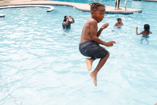Bryon Meadows, 6, jumps into the pool at at Rosa L. Burney Park Swimming Pool in Atlanta on Wednesday. (Natrice Miller/AJC)