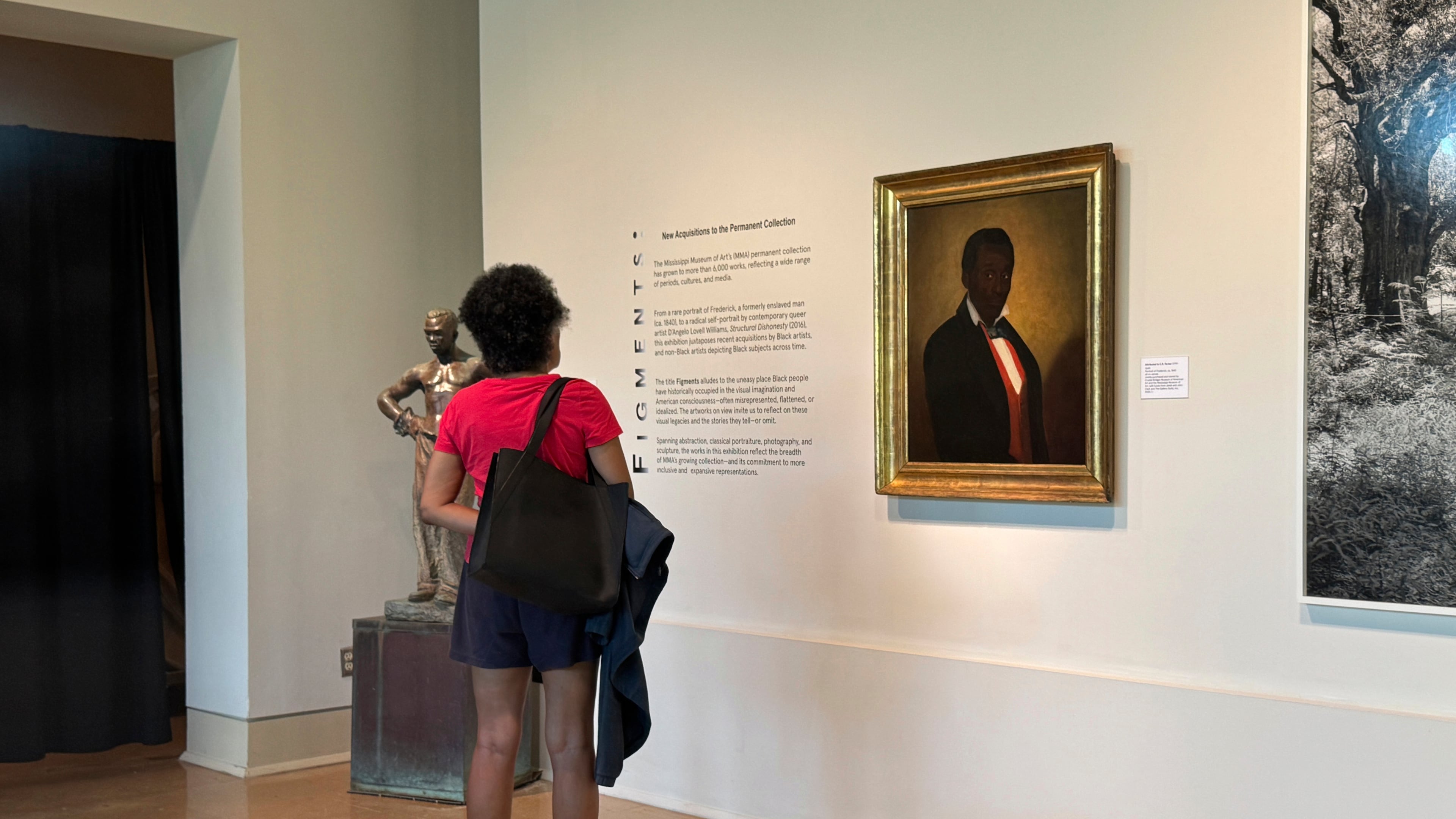 Staci Williams looks at the painting "Portrait of Frederick" at the Mississippi Museum of Art in Jackson, Miss., on Saturday, Sept. 13, 2025. (AP Photo/Sophie Bates)