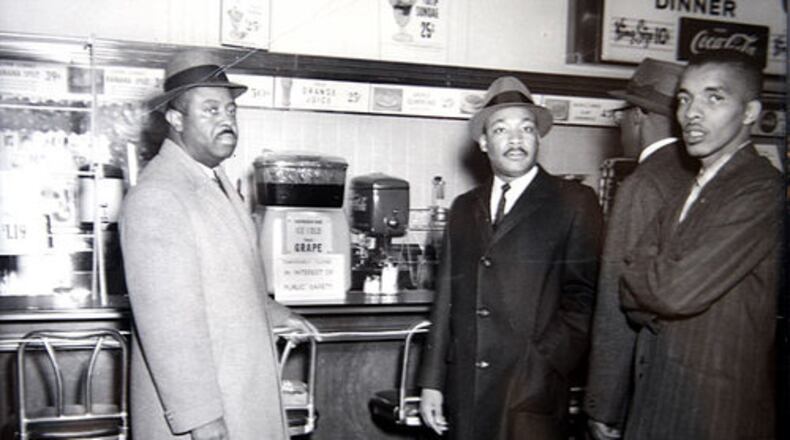Rev. Ralph David Abernathy (left) and Rev. Martin Luther King Jr. (center) stand at a lunch counter in the early 1960s. On Feb. 16, learn about renovation plans for the historic West Hunter Street Baptist Church of which Abernathy was the pastor from 1961 to 1973. Contributed