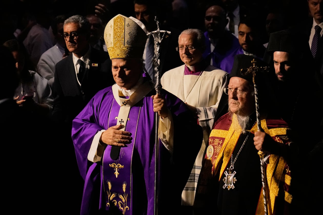 Pope Leo XIV arrives with Ecumenical Patriarch Bartholomew I, the spiritual leader of the world's Eastern Orthodox Christians to celebrate a Mass at the Volkswagen Arena, in Istanbul, Turkey, Saturday, Nov. 29, 2025. (AP Photo/Khalil Hamra)