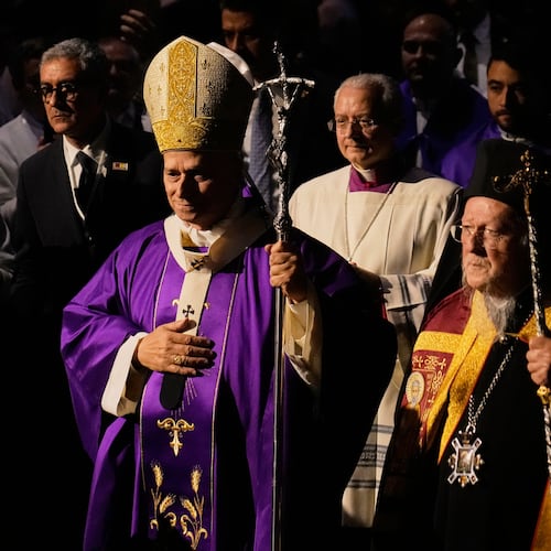 Pope Leo XIV arrives with Ecumenical Patriarch Bartholomew I, the spiritual leader of the world's Eastern Orthodox Christians to celebrate a Mass at the Volkswagen Arena, in Istanbul, Turkey, Saturday, Nov. 29, 2025. (AP Photo/Khalil Hamra)