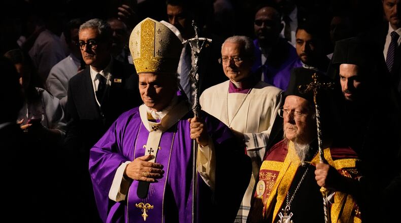 Pope Leo XIV arrives with Ecumenical Patriarch Bartholomew I, the spiritual leader of the world's Eastern Orthodox Christians to celebrate a Mass at the Volkswagen Arena, in Istanbul, Turkey, Saturday, Nov. 29, 2025. (AP Photo/Khalil Hamra)
