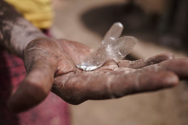 Sadio Camara, a gold processor, holds up a bag of mercury at her home in the Kedougou region of Senegal on Thursday, Jan. 16, 2025. (AP Photo/Annika Hammerschlag)