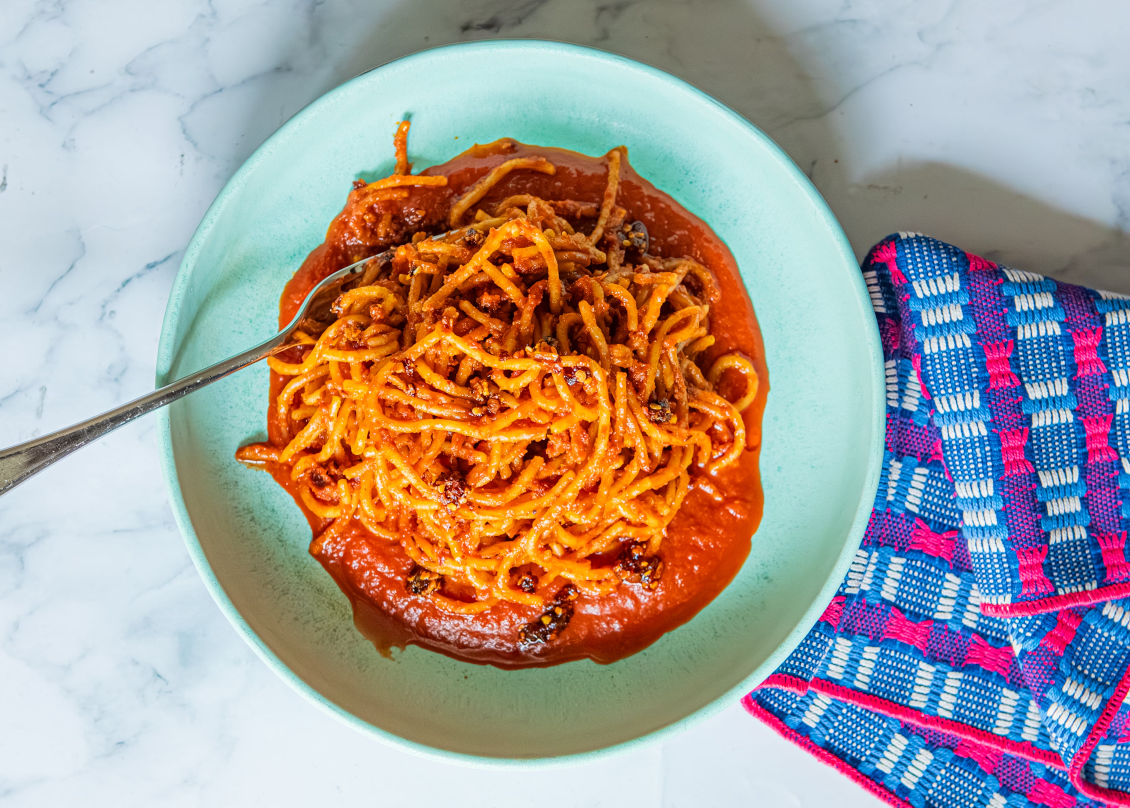 Tasty dinners, like this Chili Crisp Assassin's Spaghetti, need just a can of tomatoes and a few other staple ingredients. (Aaliyah Man for the AJC/food styling by Kate Williams)