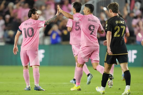 Inter Miami forward Lionel Messi (10) celebrates a goal with forward Luis Suárez (9) against the Los Angeles FC during the first half of a CONCACAF Nations League Quarterfinal Match at Chase Stadium, Wednesday, April 9, 2025 in Fort Lauderdale, Fla. (AP Photo/Jim Rassol)