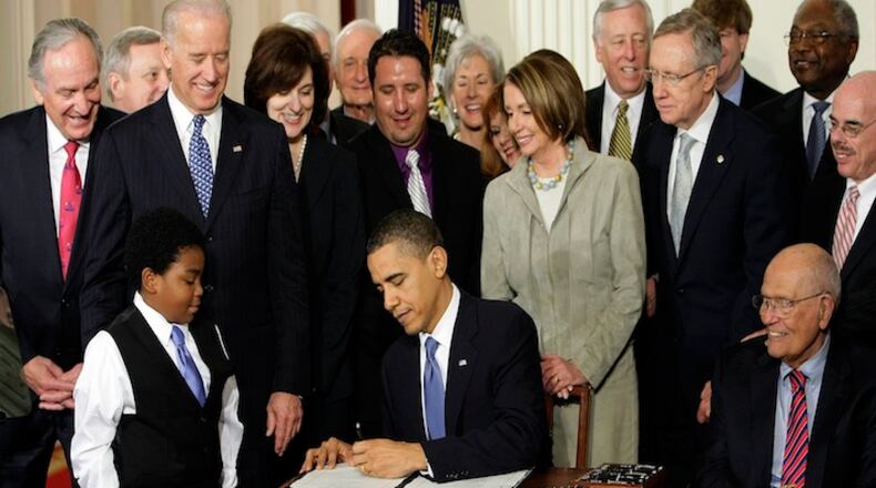 In this Tuesday, March 23, 2010 file photo, President Barack Obama signs the Patient Protection and Affordable Care Act in the East Room of the White House in Washington. "Obamacare" led to health care coverage for some 20 million Americans, including about 4 million Hispanics and 3 million blacks, according to federal statistics. (AP Photo/J. Scott Applewhite)
